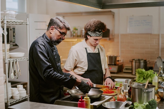 Two chefs collaborating in kitchen